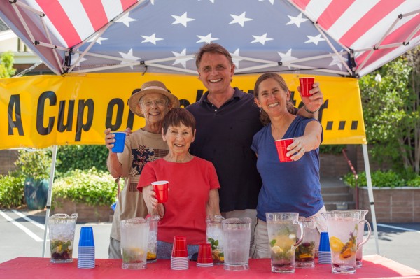 Members offering cups of cold water